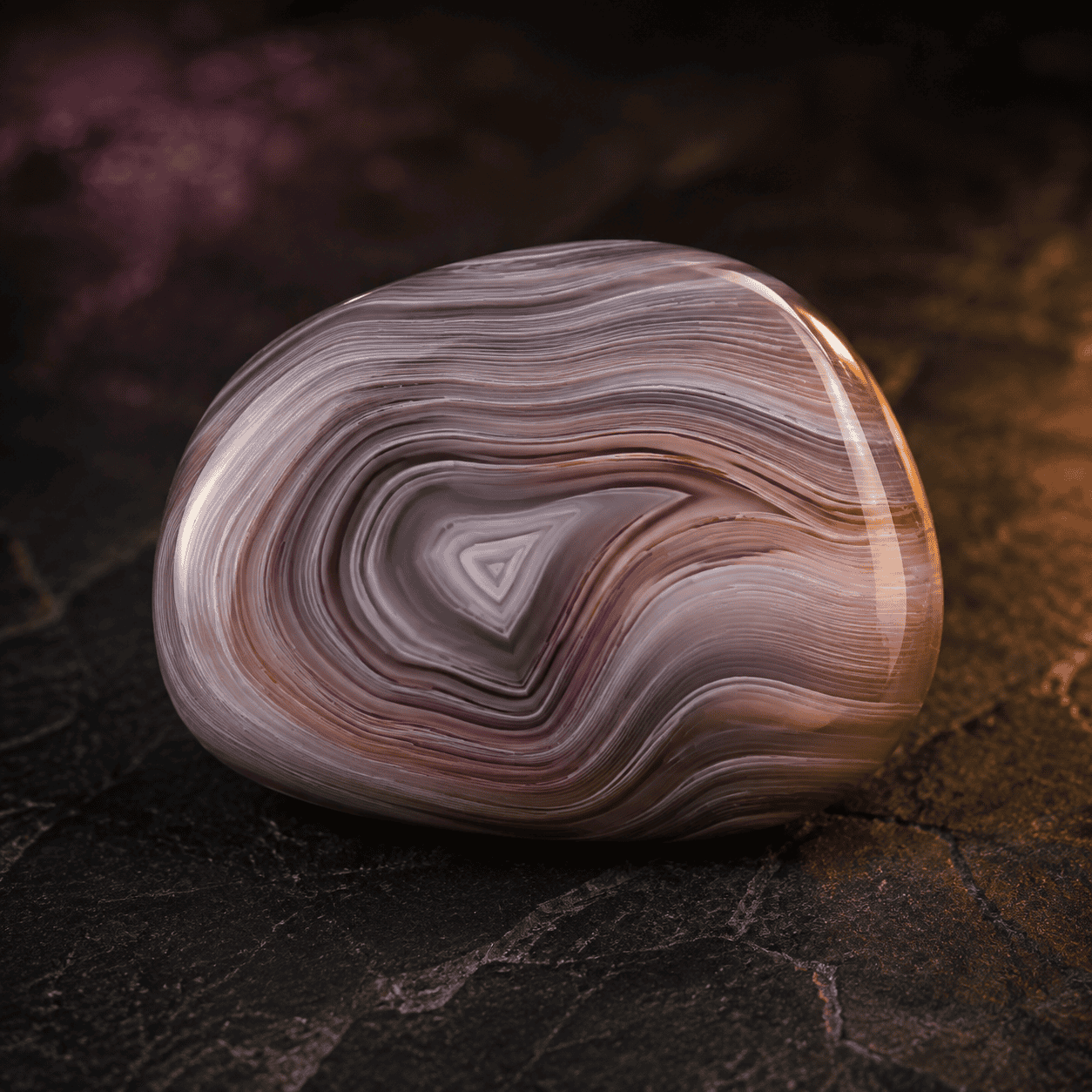 Close-up of a polished agate stone with intricate banding patterns.