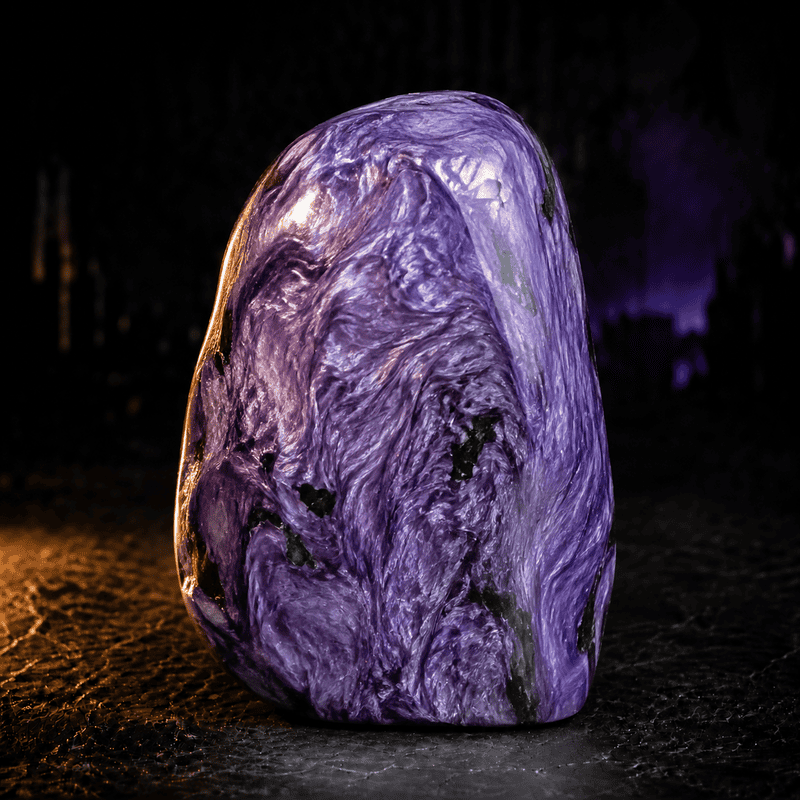 Close-up of a purple marble stone with swirling patterns and glossy surface.