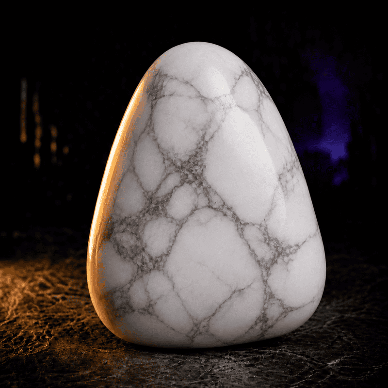 Smooth white marble stone with gray veining on dark background.