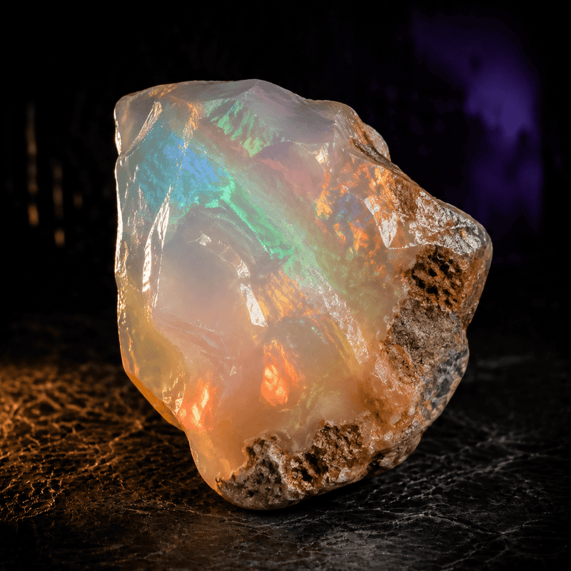 Beautiful opal gemstone displaying vibrant iridescent colors and natural rough texture.
