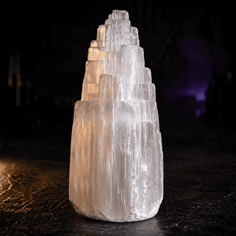 Salt crystal sculpture illuminated at night for urban art display.