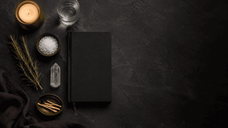 Elegant workspace with candle, notebook, and natural elements for relaxation.