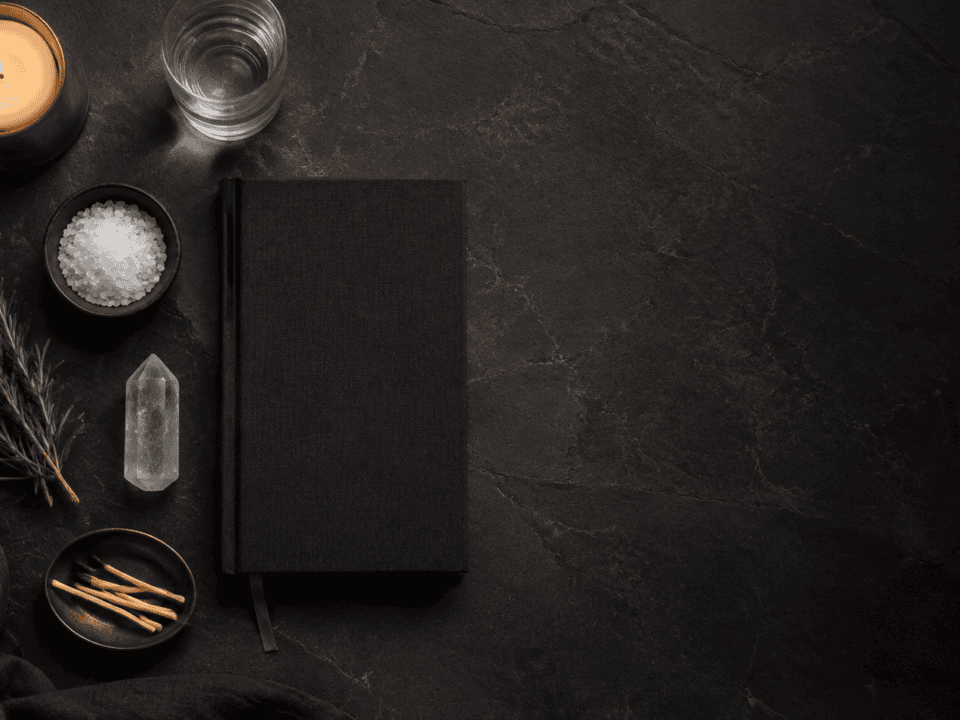 Elegant workspace with candle, notebook, and natural elements for relaxation.