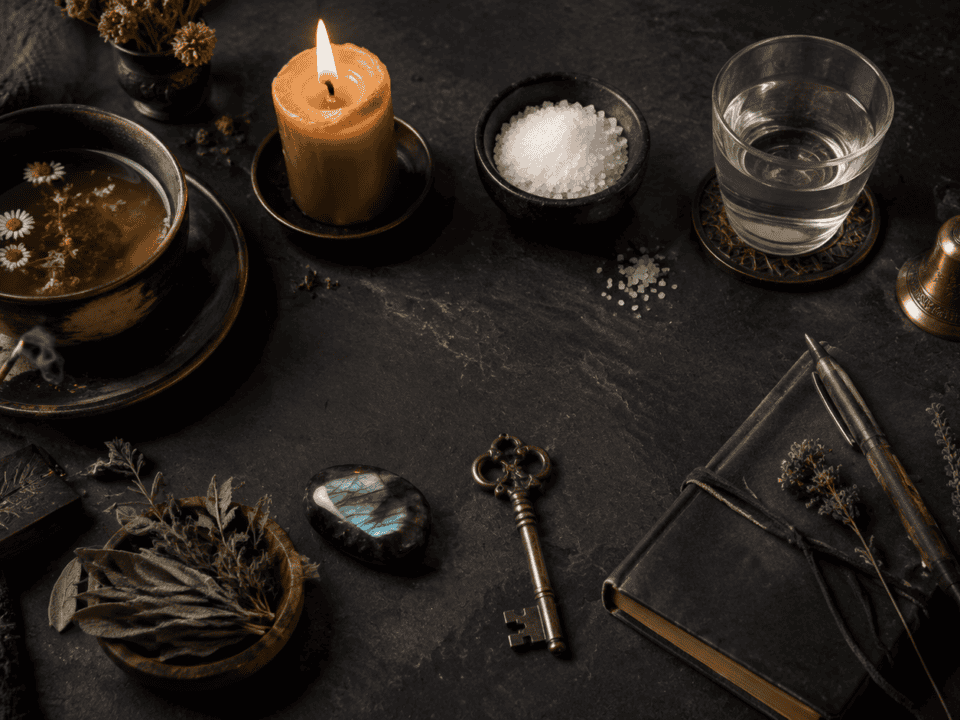 Spa setting with candle, herbs, salt, and wellness tools for relaxation.